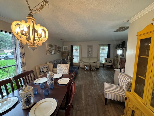 128 Hidden Lake Dr, League City, TX 77573 - dining area with a textured ceiling, dark wood-type flooring, a chandelier, and ornamental molding