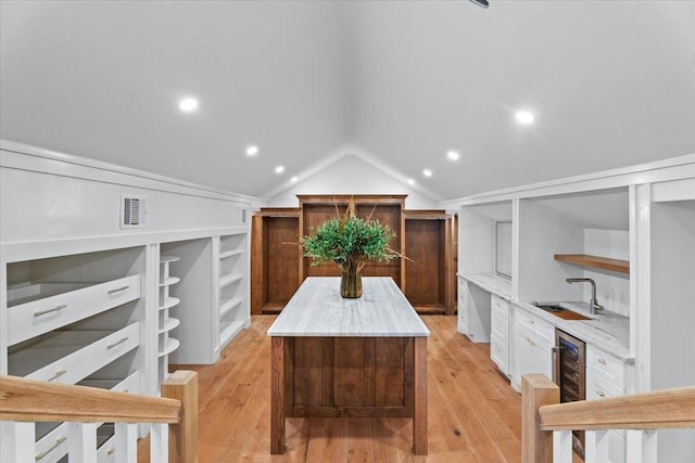1543 Columbia St, Houston, TX 77008 - spacious closet featuring light wood-style floors, wet bar, vaulted ceiling, and wine cooler