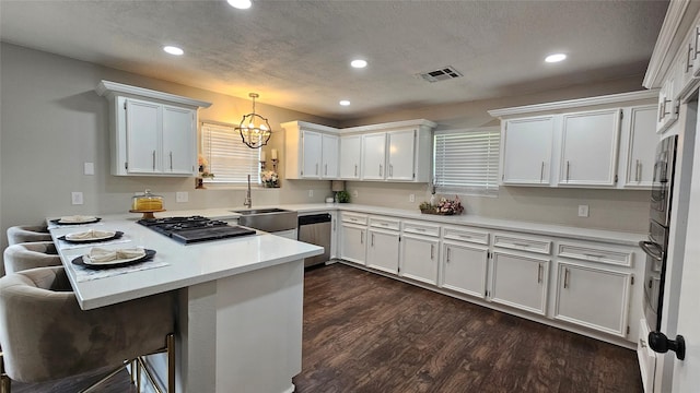 2402 Heather St, Highlands, TX 77562 - kitchen with a peninsula, recessed lighting, a chandelier, light countertops, and dark wood finished floors