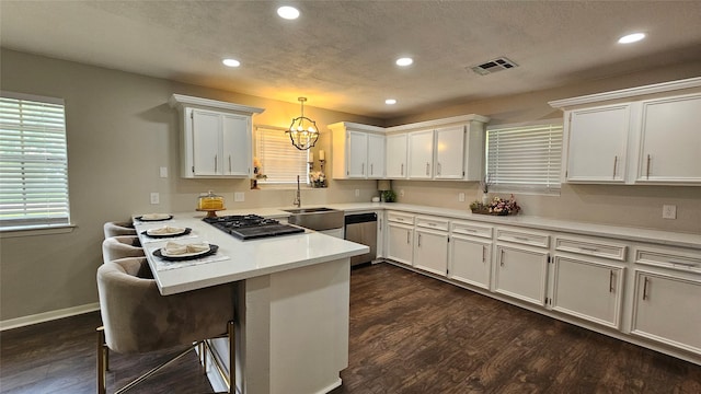 2402 Heather St, Highlands, TX 77562 - kitchen featuring a peninsula, gas cooktop, recessed lighting, a chandelier, and white cabinets
