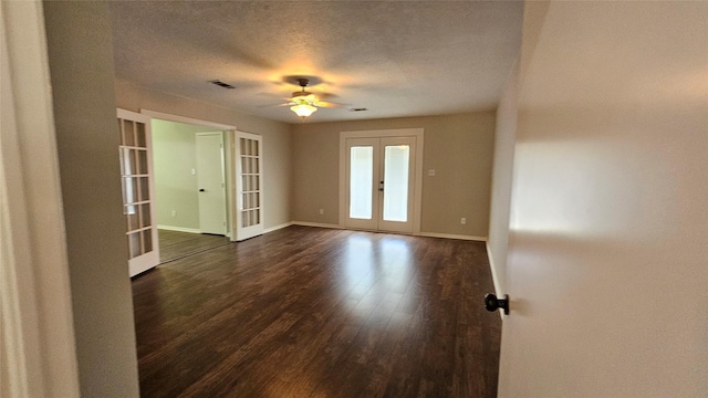 2402 Heather St, Highlands, TX 77562 - empty room featuring french doors, ceiling fan, dark wood-style floors, and a textured ceiling