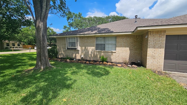 2402 Heather St, Highlands, TX 77562 - view of home's exterior with brick siding, a yard, a shingled roof, and an attached garage
