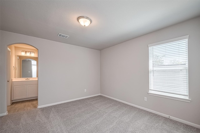 24711 Sonora Crescent Cir, Huffman, TX 77336 - spare room featuring light colored carpet and arched walkways