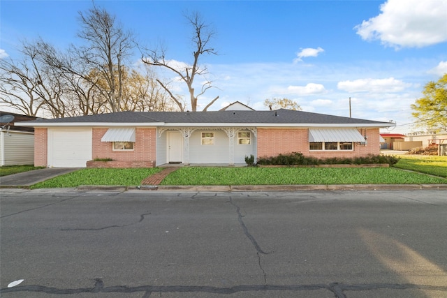 800 E Adoue St, Baytown, TX 77520 - ranch-style house with brick siding, a garage, a front lawn, and concrete driveway