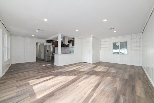 800 E Adoue St, Baytown, TX 77520 - unfurnished living room featuring a decorative wall, dark wood-type flooring, recessed lighting, and crown molding