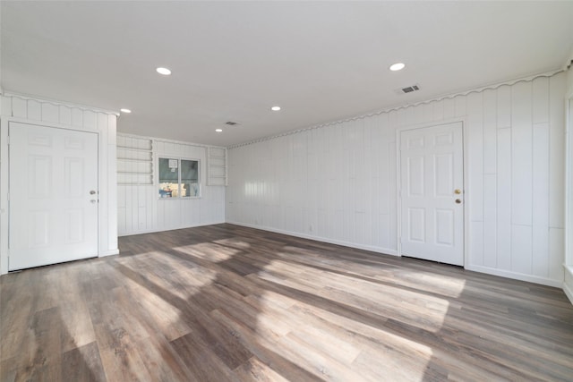 800 E Adoue St, Baytown, TX 77520 - spare room with wood finished floors, a decorative wall, and recessed lighting
