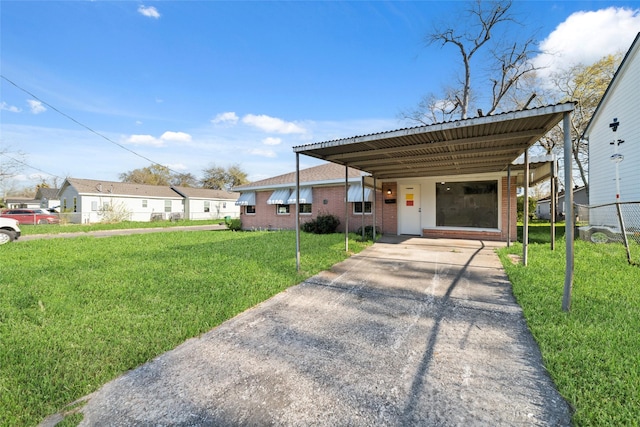 800 E Adoue St, Baytown, TX 77520 - view of front of home featuring driveway, brick siding, and an attached carport
