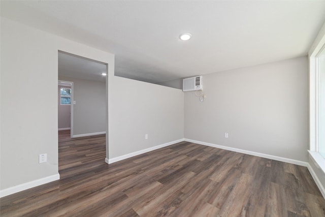 800 E Adoue St, Baytown, TX 77520 - unfurnished room featuring an AC wall unit, dark wood-style floors, and recessed lighting