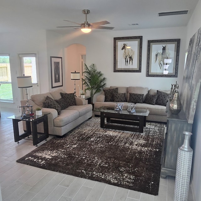 234 Emerald Thicket Ln, Huffman, TX 77336 - living area featuring ceiling fan, wood finished floors, and arched walkways