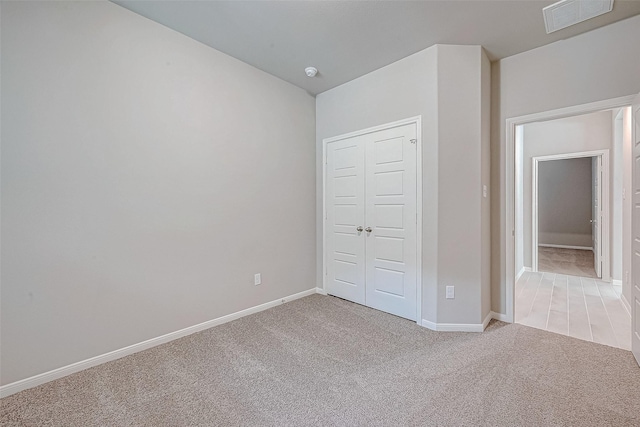 218 Emerald Thicket Ln, Huffman, TX 77336 - unfurnished bedroom featuring light colored carpet and a closet