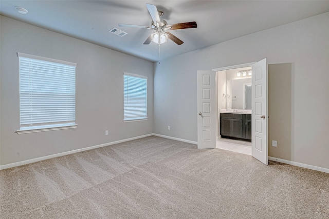 218 Emerald Thicket Ln, Huffman, TX 77336 - unfurnished bedroom with light colored carpet, ensuite bathroom, and ceiling fan