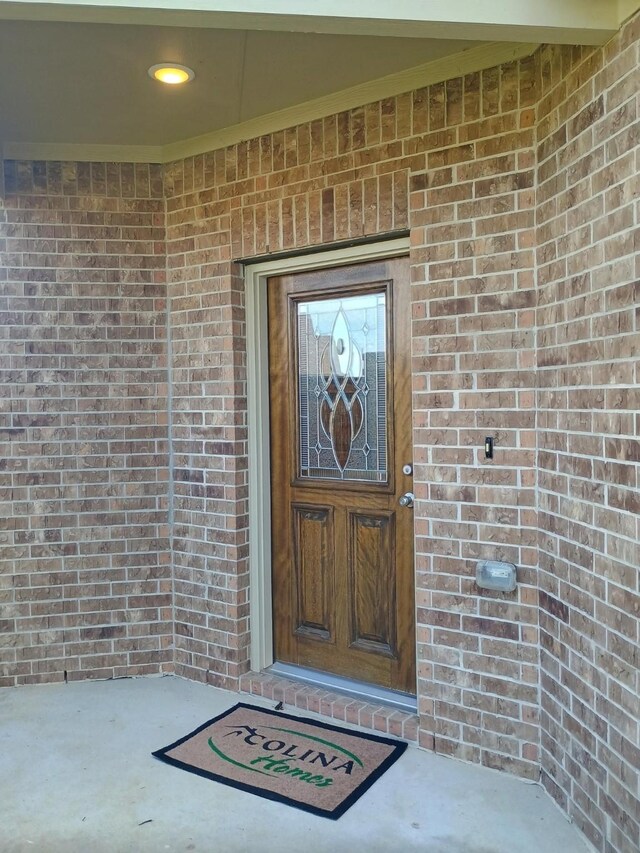 12303 Sterling Oak Dr, Humble, TX 77044 - doorway to property featuring brick siding
