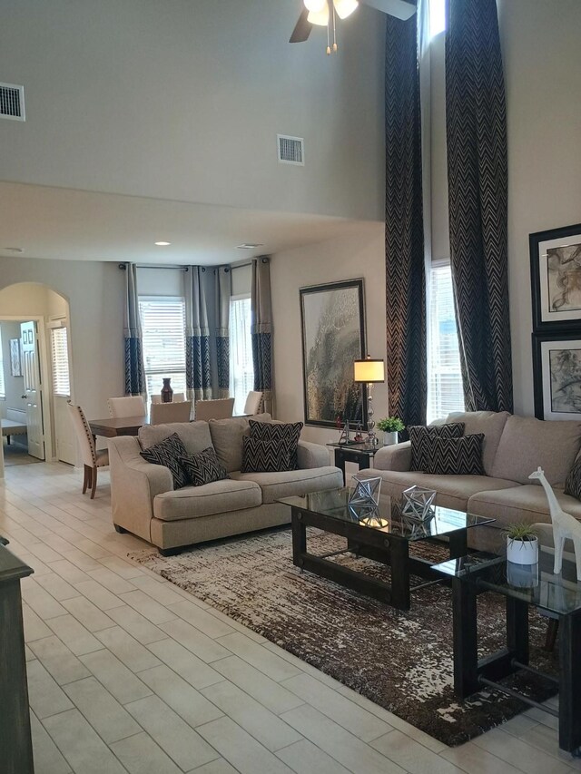 12303 Sterling Oak Dr, Humble, TX 77044 - living room with a towering ceiling, arched walkways, and a ceiling fan