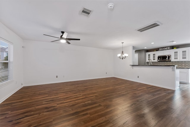 2623 Woodridge Cove Dr, Houston, TX 77087 - unfurnished living room with a chandelier, dark wood-style floors, ceiling fan, and recessed lighting