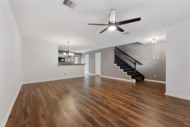 2623 Woodridge Cove Dr, Houston, TX 77087 - unfurnished living room with a chandelier, stairs, dark wood-style flooring, and a ceiling fan