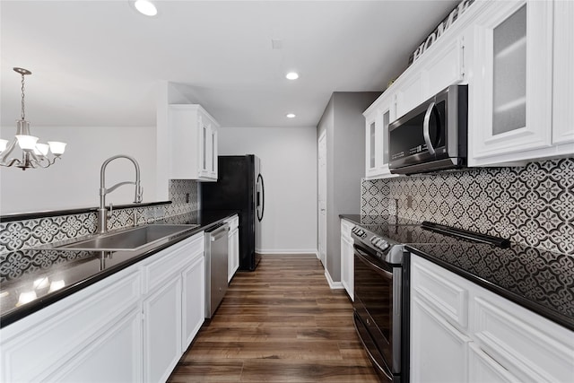 2623 Woodridge Cove Dr, Houston, TX 77087 - kitchen featuring black appliances, dark countertops, tasteful backsplash, glass insert cabinets, and white cabinets