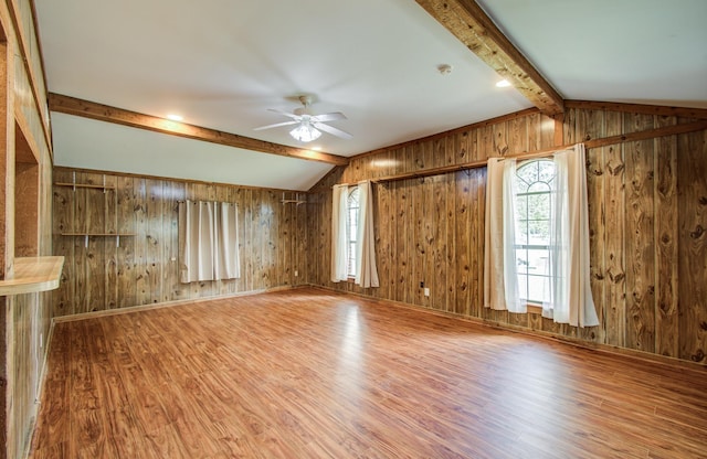 810 Roosevelt St, Sealy, TX 77474 - unfurnished living room featuring wood finished floors, ceiling fan, and wood walls
