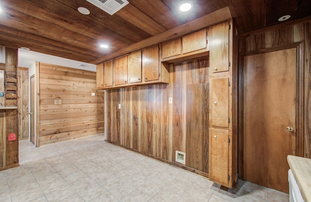 810 Roosevelt St, Sealy, TX 77474 - kitchen with wood ceiling, wood walls, brown cabinetry, and recessed lighting
