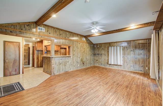 810 Roosevelt St, Sealy, TX 77474 - unfurnished living room featuring ceiling fan, wooden walls, and light wood finished floors
