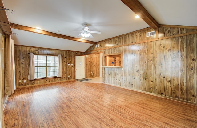 810 Roosevelt St, Sealy, TX 77474 - spare room featuring ceiling fan, wood finished floors, and wood walls
