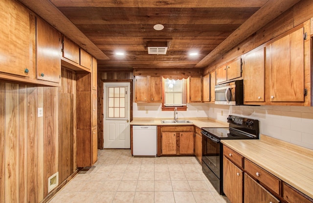 810 Roosevelt St, Sealy, TX 77474 - kitchen featuring white dishwasher, black range with electric cooktop, stainless steel microwave, wooden ceiling, and light countertops