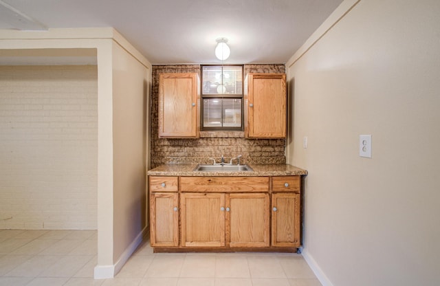 810 Roosevelt St, Sealy, TX 77474 - bar area featuring light tile patterned floors, decorative backsplash, and brick wall
