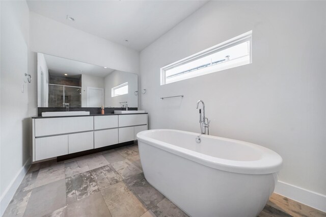 5509 Paraiso Pl, Houston, TX 77091 - full bath featuring double vanity, a soaking tub, and a stall shower