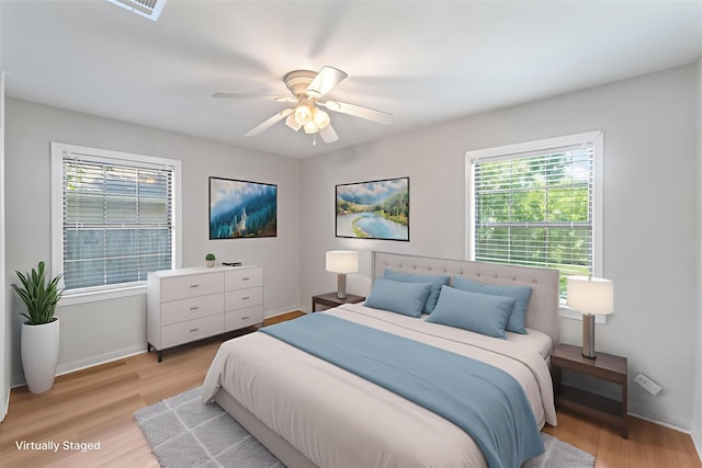 4517 W 43rd St, Houston, TX 77092 - bedroom with light wood-style flooring, multiple windows, and a ceiling fan