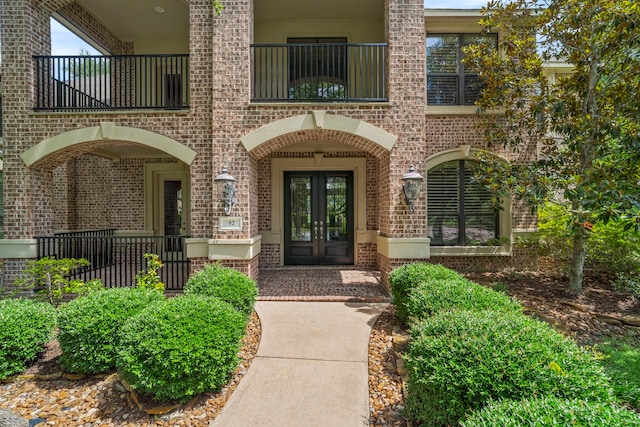 52 Tall Trl, Missouri City, TX 77459 - view of exterior entry featuring french doors, a balcony, and brick siding