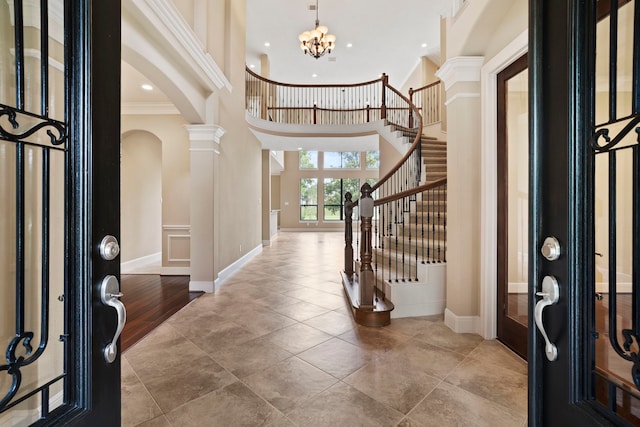 52 Tall Trl, Missouri City, TX 77459 - foyer with arched walkways, crown molding, decorative columns, stairway, and a high ceiling
