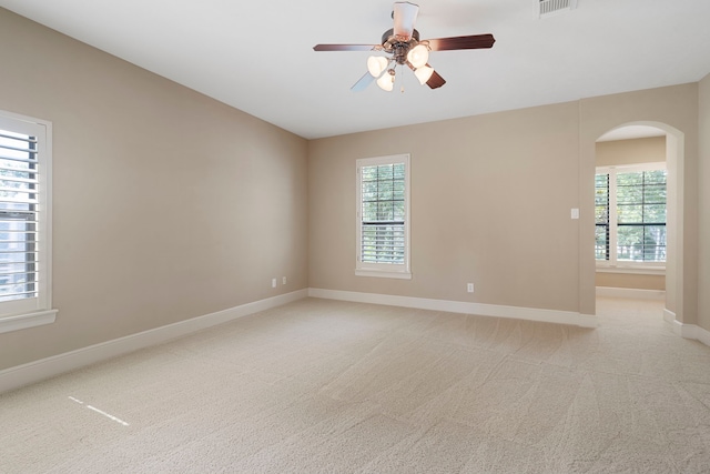 52 Tall Trl, Missouri City, TX 77459 - spare room featuring arched walkways, ceiling fan, and light carpet