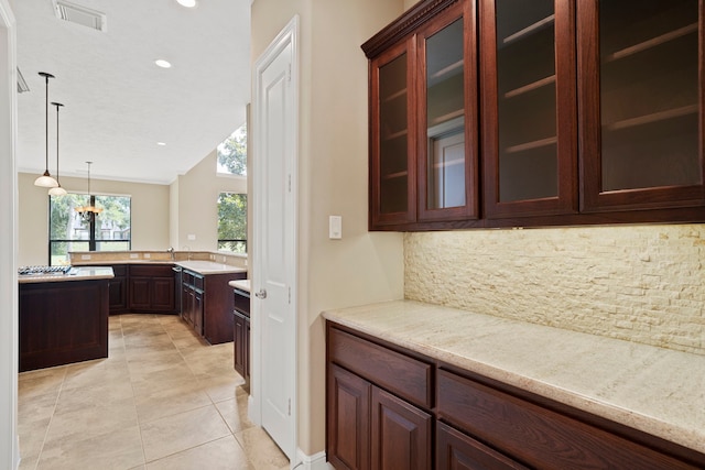 52 Tall Trl, Missouri City, TX 77459 - kitchen featuring decorative backsplash, light tile patterned floors, glass insert cabinets, pendant lighting, and recessed lighting