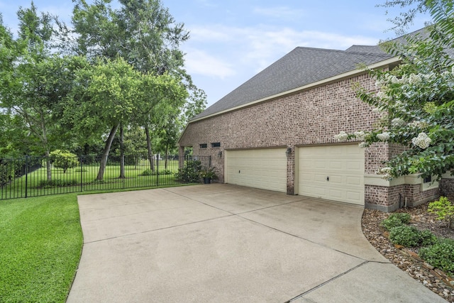 52 Tall Trl, Missouri City, TX 77459 - view of side of home with brick siding, driveway, roof with shingles, and a garage