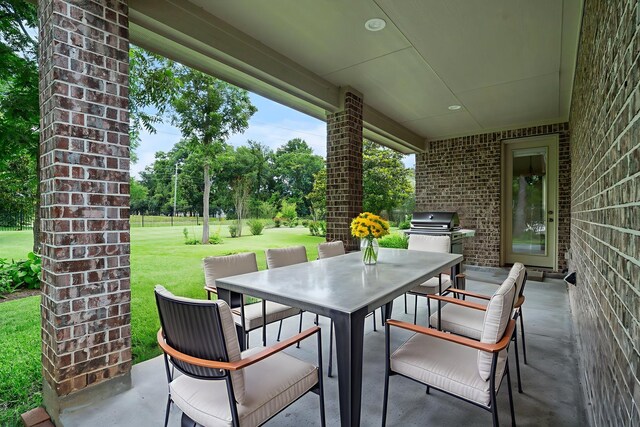 52 Tall Trl, Missouri City, TX 77459 - view of patio / terrace featuring outdoor dining space, exterior kitchen, and view of wooded area