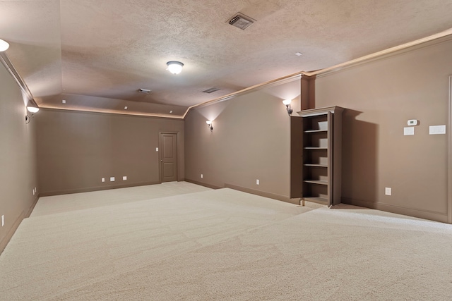 52 Tall Trl, Missouri City, TX 77459 - empty room with lofted ceiling, a textured ceiling, carpet floors, and ornamental molding