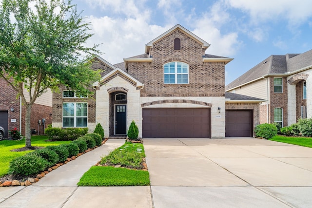 10118 Cypress Path, Missouri City, TX 77459 - view of front of property with brick siding, concrete driveway, a garage, stone siding, and a shingled roof