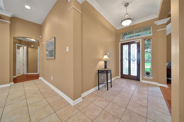 22710 Sierra Lake Ct, Katy, TX 77494 - foyer entrance featuring light tile patterned floors, arched walkways, ornamental molding, and a towering ceiling