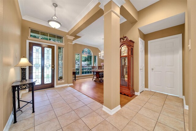22710 Sierra Lake Ct, Katy, TX 77494 - foyer with light tile patterned floors, decorative columns, ornamental molding, and a chandelier