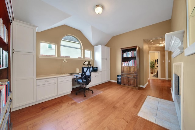 22710 Sierra Lake Ct, Katy, TX 77494 - office featuring light wood-style flooring, attic access, vaulted ceiling, and built in study area