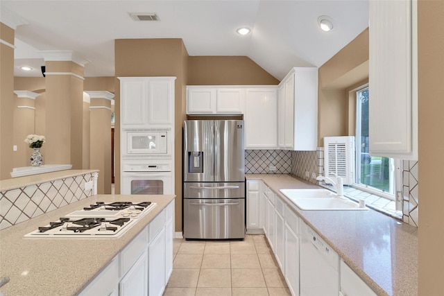 22710 Sierra Lake Ct, Katy, TX 77494 - kitchen with white appliances, backsplash, white cabinets, lofted ceiling, and recessed lighting