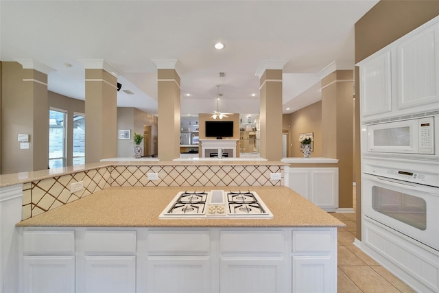 22710 Sierra Lake Ct, Katy, TX 77494 - kitchen with white appliances, ceiling fan, ornate columns, white cabinets, and open floor plan