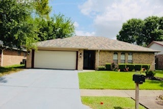 5923 Pine Needle Ln, Pasadena, TX 77505 - view of front facade featuring driveway, a garage, and a front lawn