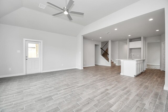 12030 Maple Oak Dr, Houston, TX 77066 - unfurnished living room featuring lofted ceiling, recessed lighting, stairway, a ceiling fan, and light wood-type flooring
