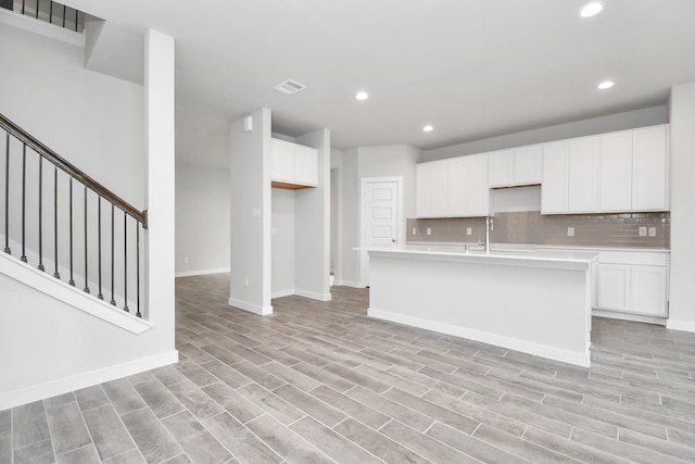 12030 Maple Oak Dr, Houston, TX 77066 - kitchen featuring recessed lighting, backsplash, white cabinetry, and light countertops