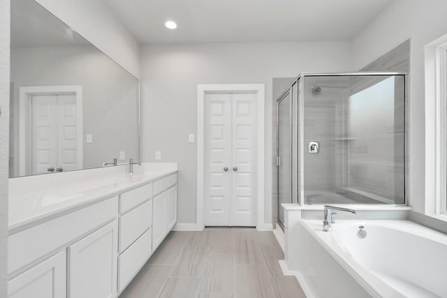 12030 Maple Oak Dr, Houston, TX 77066 - full bath with a garden tub, a stall shower, double vanity, a closet, and recessed lighting