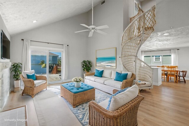 4034 Reeves Dr, Galveston, TX 77554 - living room with wood finished floors, a textured ceiling, recessed lighting, high vaulted ceiling, and a ceiling fan