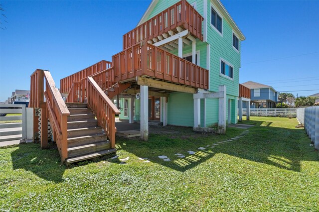 4034 Reeves Dr, Galveston, TX 77554 - rear view of house with stairs and a wooden deck