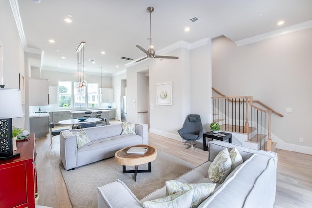 739 Bringhurst St, Houston, TX 77020 - living area featuring light wood-style floors, ornamental molding, recessed lighting, stairway, and ceiling fan