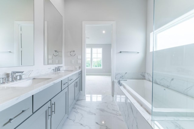 739 Bringhurst St, Houston, TX 77020 - bathroom with marble tiled floors, double vanity, and a tub with marble appearance