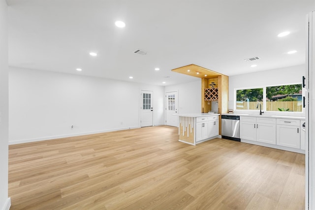 3303 Dartmouth Dr, Pasadena, TX 77503 - kitchen with dishwasher, white cabinetry, light wood-style flooring, recessed lighting, and open floor plan